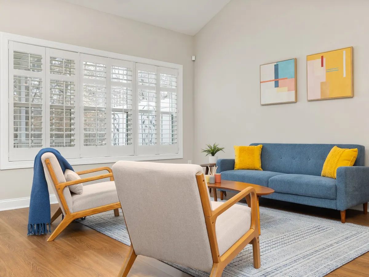 Bright, tidy living room with a blue sofa